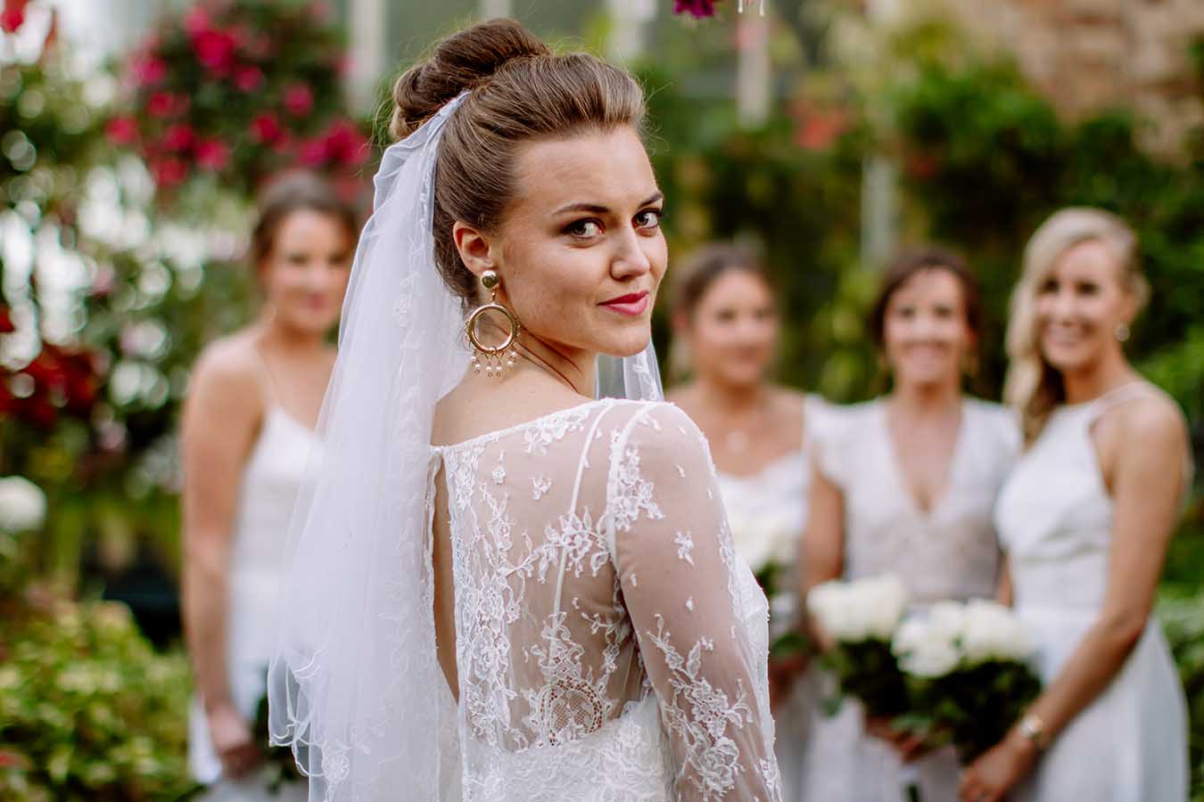Auckland Wedding Photographer.Bride and bridesmaids at the bridal party outside Auckland Wintergardens